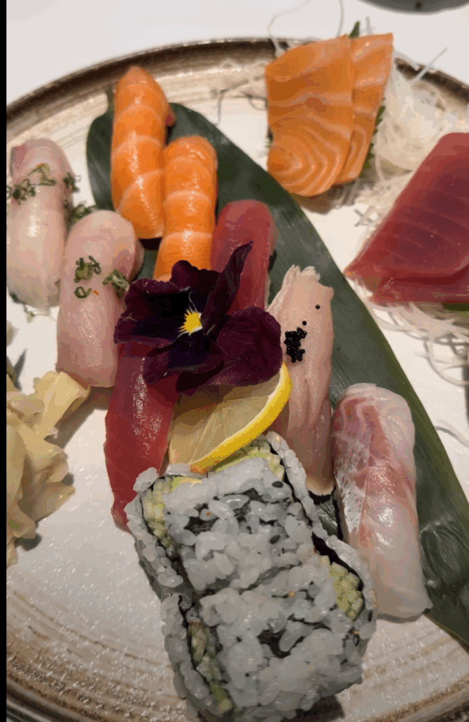 Big family meal with the team sharing food and good times over an assorted sushi platter